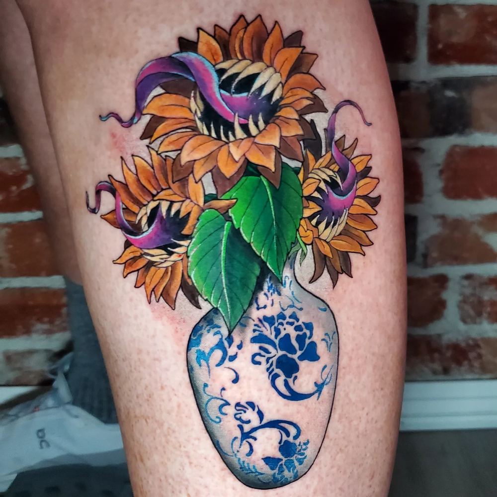 Sunflowers in a vase tattoo by Adrian Castro