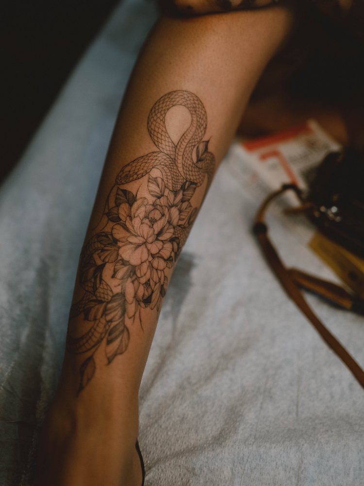 Floral linework tattoo by Ash Barroga