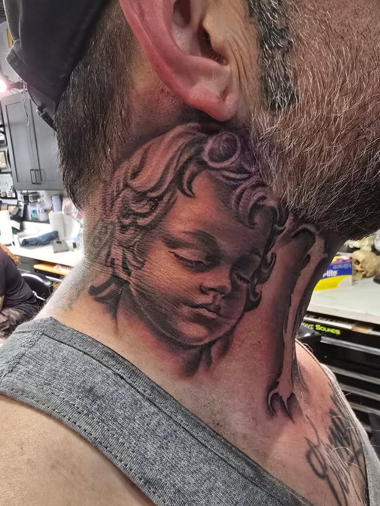 Cherub memorial tattoo by Jason Lawson