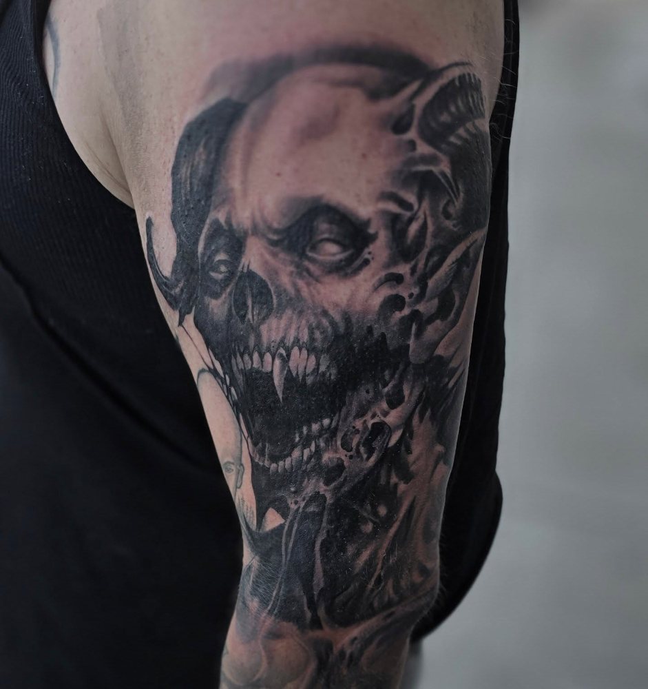 Half face, half skull tattoo by Jason Lawson